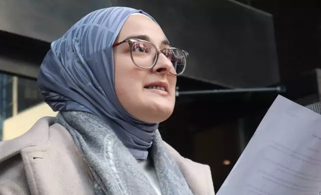 Tufts University doctoral student Rumeysa Ozturk reads from a prepared statement following a court hearing outside the John Joseph Moakley United States Courthouse Thursday, Dec. 4, 2025, in Boston. (AP Photo/Leah Willingham)