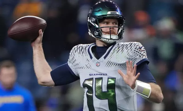 Seattle Seahawks quarterback Sam Darnold (14) throws during the first half of an NFL football game against the Los Angeles Rams, Thursday, Dec. 18, 2025, in Seattle. (AP Photo/Lindsey Wasson)