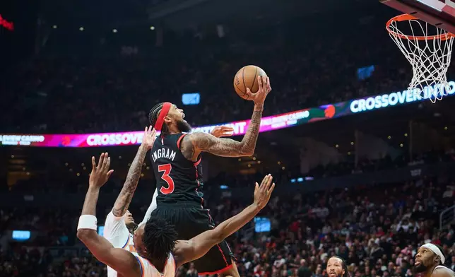 Toronto Raptors' Brandon Ingram (3) drives to the net during the first half of an NBA Cup basketball game against the New York Knicks in Toronto, Tuesday, Dec. 9, 2025. (Sammy Kogan/The Canadian Press via AP)