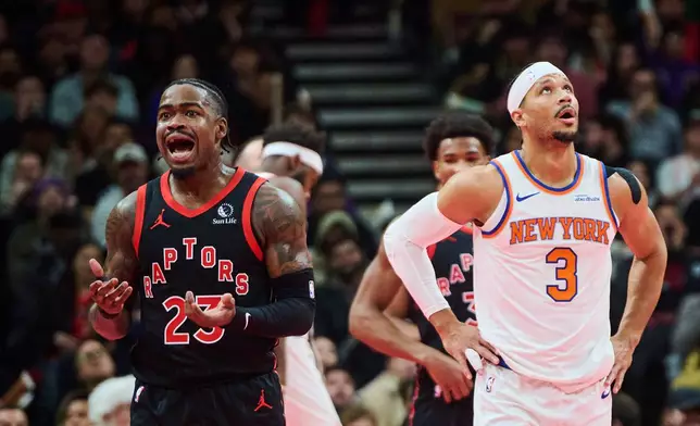 Toronto Raptors' Jamal Shead, left, and New York Knicks' Josh Hart (3) react to a call during the first half of an NBA Cup basketball game in Toronto, Tuesday, Dec. 9, 2025. (Sammy Kogan/The Canadian Press via AP)