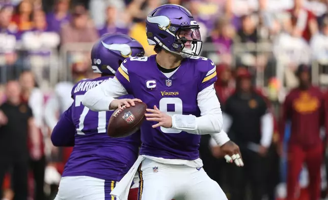 Minnesota Vikings quarterback J.J. McCarthy (9) looks to pass during the first half of an NFL football game against the Washington Commanders, Sunday, Dec. 7, 2025, in Minneapolis. (AP Photo/Matt Krohn)