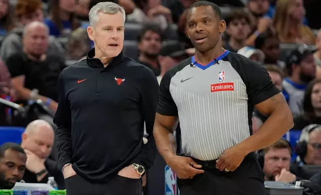 Chicago Bulls head coach Billy Donovan, left, talks with official Dedric Taylor during the first half of an NBA basketball game, Monday, Dec. 1, 2025, in Orlando, Fla. (AP Photo/John Raoux)