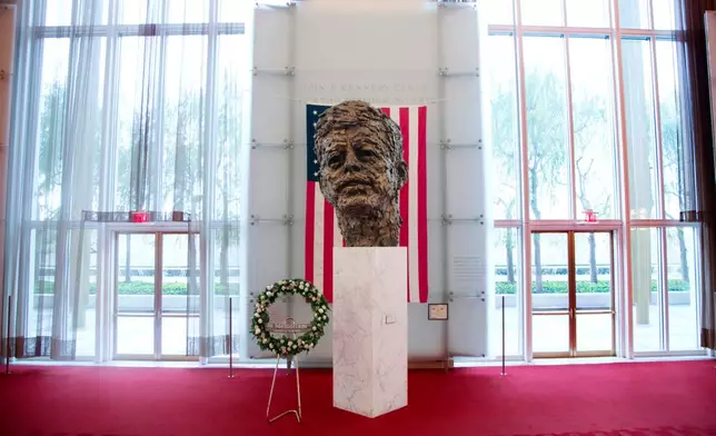 FILE - A memorial wreath stands next to the bronze memorial bust by Robert Berks of President John F. Kennedy in the grand foyer at the John F. Kennedy Center for the Performing Arts in Washington, Nov. 22, 2013, on the 50th anniversary of Kennedy's death. (AP Photo/Carolyn Kaster, File)