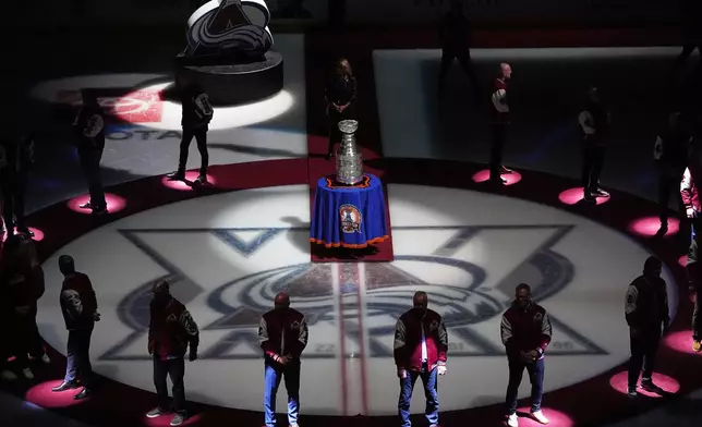 Members of the 1996 Stanley Cup Championship team from the Colorado Avalanche are honored to mark the 30th anniversary of winning the Cup before an NHL hockey game against the Florida Panthers Thursday, Dec. 11, 2025, in Denver. (AP Photo/David Zalubowski)