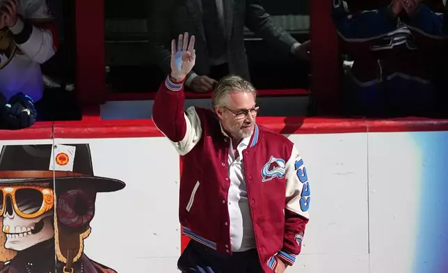 Peter Forsberg waves as he is introduced as one of the members from the Colorado Avalanche's 1996 Stanley Cup Championship team during a ceremony to mark the 30th anniversary of the victory before an NHL hockey game against the Florida Panthers, Thursday, Dec. 11, 2025, in Denver. (AP Photo/David Zalubowski)