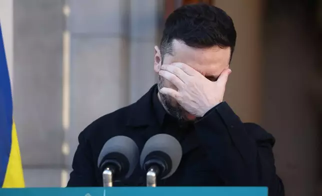 Ukraine's President Volodymyr Zelenskyy, reacts as he takes part in a joint press conference with the Irish Prime Minister Micheal Martin in Dublin, Ireland, Tuesday, Dec. 2, 2025. (AP Photo/Peter Morrison)