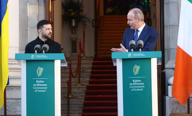 Ukraine President Volodymyr Zelenskyy, left, listens to the Irish Prime Minister Micheal Martin as they hold a joint press conference in Dublin, Ireland, Tuesday, Dec. 2, 2025. (AP Photo/Peter Morrison)