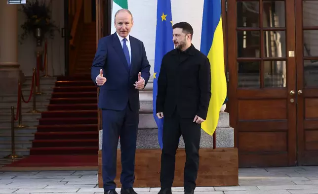 CAPTION CORRECTS SPELLING OF NAME Ukraine's President Volodymyr Zelenskyy, right, poses with the Irish Prime Minister Micheal Martin upon his arrival at Government Buildings in Dublin, Ireland, Tuesday, Dec. 2, 2025. (AP Photo/Peter Morrison)