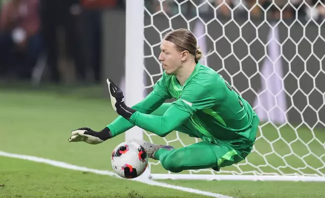 PSG's goalkeeper Matvey Safonov stop a ball in the penalty shootout during the FIFA Intercontinental Cup final soccer match between Flamengo and Paris Saint-Germain in Doha, Qatar, Wednesday, Dec. 17, 2025. (AP Photo/Hussein Sayed)