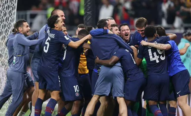 PSG players celebrate after winning the FIFA Intercontinental Cup final soccer match between Flamengo and Paris Saint-Germain in Doha, Qatar, Wednesday, Dec. 17, 2025. (AP Photo/Hussein Sayed)
