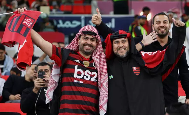 Flamengo fans pose for a photograph prior to the start of the FIFA Intercontinental Cup final soccer match between Flamengo and Paris Saint-Germain in Doha, Qatar, Wednesday, Dec. 17, 2025. (AP Photo/Hussein Sayed)