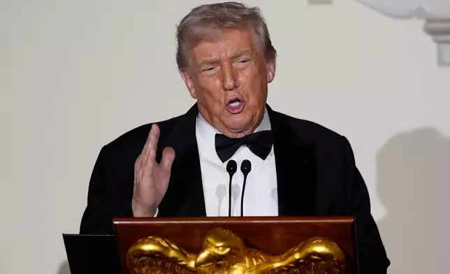 President Donald Trump speaks to guests in the Grand Foyer of the White House during the Congressional Ball, Thursday, Dec. 11, 2025, in Washington. (AP Photo/Alex Brandon)