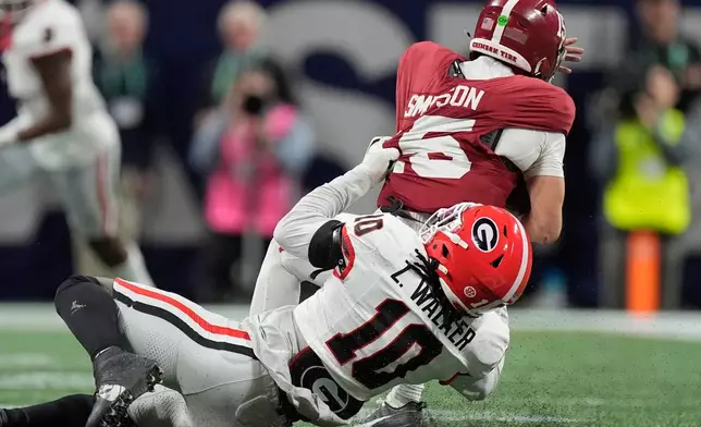 Georgia linebacker Zayden Walker (10) hits Alabama quarterback Ty Simpson (15) during the second half of a Southeastern Conference championship NCAA college football game, Saturday, Dec. 6, 2025, in Atlanta. (AP Photo/Mike Stewart)