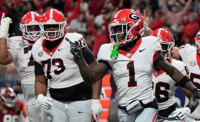 Georgia wide receiver Zachariah Branch (1) celebrates his touchdown against Alabama during the second half of a Southeastern Conference championship NCAA college football game, Saturday, Dec. 6, 2025, in Atlanta. (AP Photo/Mike Stewart)