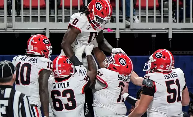 Georgia running back Roderick Robinson II (0) celebrates his touchdown against Alabama during the first half of a Southeastern Conference championship NCAA college football game, Saturday, Dec. 6, 2025, in Atlanta. (AP Photo/Mike Stewart)