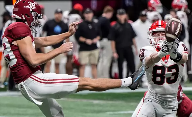 Georgia's Cole Speer (83) blocks a punt by Alabama punter Blake Doud (38) during the first half of a Southeastern Conference championship NCAA college football game, Saturday, Dec. 6, 2025, in Atlanta. (AP Photo/Mike Stewart)