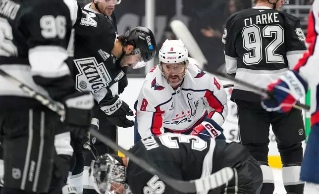 Washington Capitals left wing Alex Ovechkin, second from right, waits for the puck to come loose as Los Angeles Kings left wing Andrei Kuzmenko, left, center Anze Kopitar, second from left, center Phillip Danault, third from left, goaltender Darcy Kuemper, below, and defenseman Brandt Clarke stand by during the first period of an NHL hockey game Tuesday, Dec. 2, 2025, in Los Angeles. (AP Photo/Mark J. Terrill)