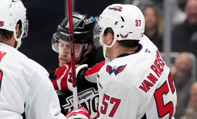 Washington Capitals defenseman Trevor van Riemsdyk, right, scuffles with Los Angeles Kings right wing Alex Laferriere during the second period of an NHL hockey game Tuesday, Dec. 2, 2025, in Los Angeles. (AP Photo/Mark J. Terrill)