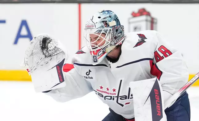 Washington Capitals goaltender Logan Thompson makes a glove save during the second period of an NHL hockey game against the Los Angeles Kings, Tuesday, Dec. 2, 2025, in Los Angeles. (AP Photo/Mark J. Terrill)