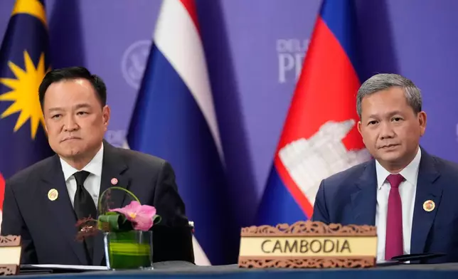 FILE - Cambodian Prime Minister Hun Manet, right, and Thailand's Prime Minister Anutin Charnvirakul, left, react during a signing ceremony on the sidelines of the ASEAN Summit in Kuala Lumpur, Malaysia, Sunday, Oct. 26, 2025. (AP Photo/Mark Schiefelbein, File)