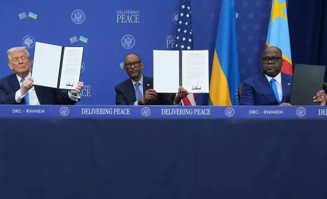 President Donald Trump, Rwanda's President Paul Kagame and Democratic Republic of Congo President Felix-Antoine Tshisekedi, during a signing ceremony at the U.S. Institute of Peace, Thursday, Dec. 4, 2025, in Washington. (AP Photo/Evan Vucci)