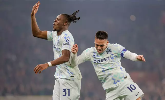 Inter's Yann-Aurel Bisseck celebrates after scoring a goal during the Serie A soccer match between Genoa and Inter, in Genoa, Italy, Sunday, Dec. 14, 2025. (Tano Pecoraro/LaPresse via AP)