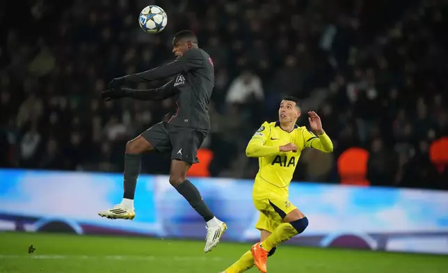 PSG's Ousmane Dembele heads the ball during a Champions League opening phase soccer match between Paris Saint Germain and Tottenham, in Paris, Wednesday, Nov.26, 2025. (AP Photo/Christophe Ena)