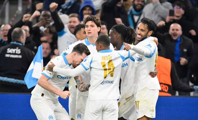Marseille's Pierre-Emerick Aubameyang, right, celebrates after scoring a goal during a Champions League opening phase soccer match between Marseille and Newcastle United in Marseille, France, Tuesday, Nov. 25, 2025. (AP Photo/Philippe Magoni)