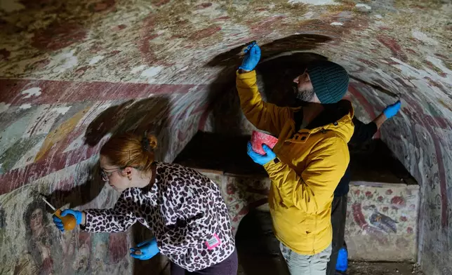 Archaeologists clean and restore frescoes inside a 3rd-century tomb where a rare early Christian depiction of Jesus as the "Good Shepherd" was discovered, in Iznik, Turkey, Friday, Dec. 12, 2025. (AP Photo/Khalil Hamra)