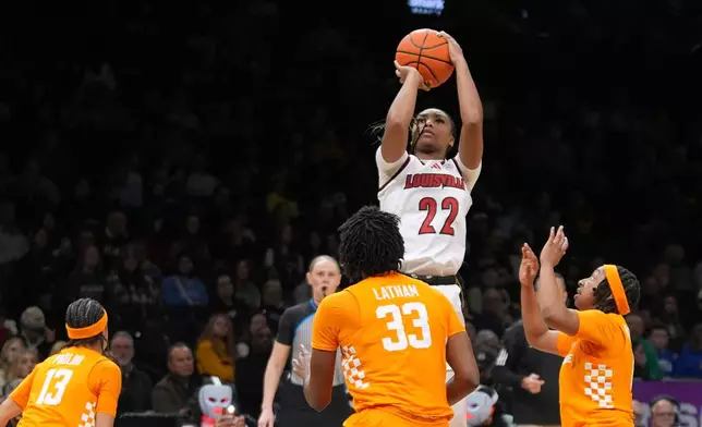 Louisville's Tajianna Roberts (22) shoots over Tennessee's Alyssa Latham (33) during the second half of an NCAA college basketball game Saturday, Dec. 20, 2025, in New York. (AP Photo/Frank Franklin II)