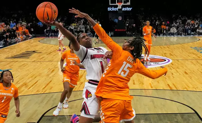 Louisville's Reyna Scott (1) shoots over Tennessee's Jaida Civil (15) during the second half of an NCAA college basketball game Saturday, Dec. 20, 2025, in New York. (AP Photo/Frank Franklin II)