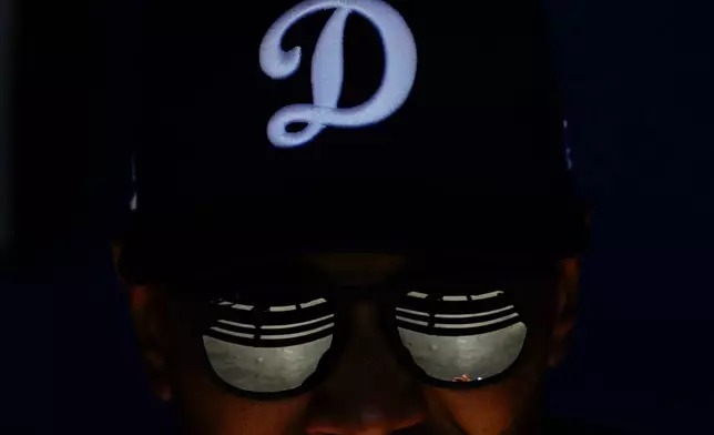 Los Angeles Dodgers shortstop Mookie Betts sits in the dugout during a spring training baseball game against the Chicago Cubs, Feb. 20, 2025, in Phoenix. (AP Photo/Ashley Landis, File)