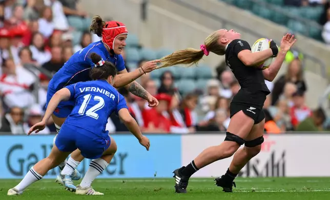 New Zealand's Jorja Miller gets her hair pulled by Charlotte Escudero of France during the Women's Rugby World Cup bronze match between New Zealand and France at the Allianz Stadium, Twickenham, London, Sept. 27, 2025. (AP Photo/Anthony Upton, File)