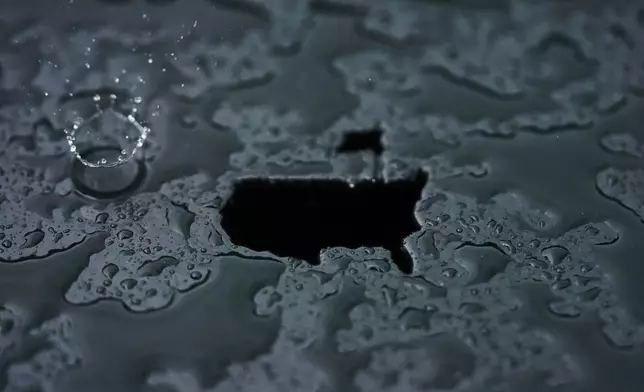 A rain droplet falls on a Masters logo cut out during a practice round at the Masters golf tournament, April 7, 2025, in Augusta, Ga. (AP Photo/Matt Slocum, File)