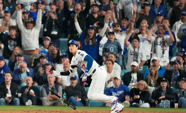 Los Angeles Dodgers' Shohei Ohtani watches his RBI-Double against the Toronto Blue Jays during the fifth inning in Game 3 of baseball's World Series, Oct. 27, 2025, in Los Angeles. (AP Photo/Mark J. Terrill, File)
