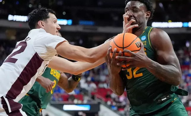 Baylor guard Jalen Celestine (32) is fouled by Mississippi State forward RJ Melendez, left, during the first half in the first round of the NCAA college basketball tournament, March 21, 2025, in Raleigh, N.C. (AP Photo/Stephanie Scarbrough, File)