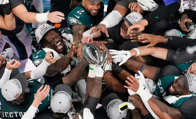 Philadelphia Eagles players celebrate with the Vince Lombardi Trophy after the Eagles won the NFL Super Bowl 59 football game against the Kansas City Chiefs, Feb. 9, 2025, in New Orleans. (AP Photo/David J. Phillip, File)