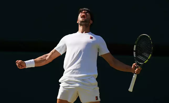 Carlos Alcaraz of Spain celebrates winning the men's semifinal singles match against Taylor Fritz of the U.S. at the Wimbledon Tennis Championships in London, July 11, 2025.(AP Photo/Kirsty Wigglesworth, File)