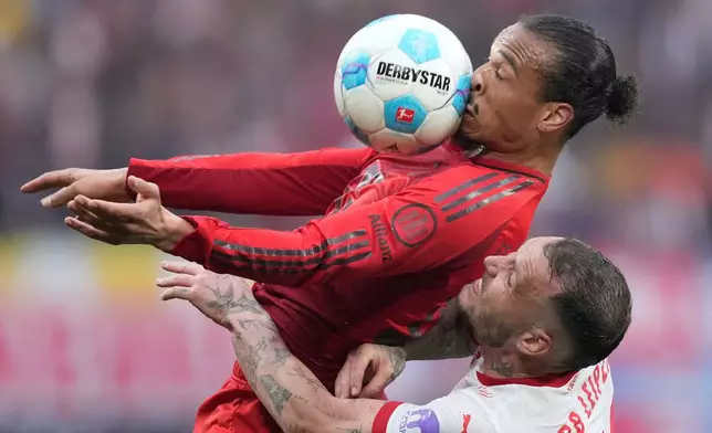 Bayern's Leroy Sane challenges for the ball with Leipzig's David Raum, bottom, during the German Bundesliga soccer match between RB Leipzig and FC Bayern Munich at the Red Bull Arena in Leipzig, Germany, May 3, 2025. (AP Photo/Ebrahim Noroozi, File)