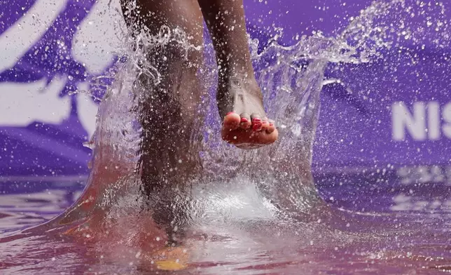 Kazakhstan's Daisy Jepkemei competes in a heat of the women's 3,000 meters steeplechase after losing a shoe at the World Athletics Championships in Tokyo, Sept. 15, 2025. (AP Photo/Ashley Landis, File)