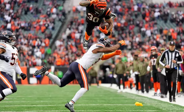Cincinnati Bengals running back Chase Brown (30) hurdles Chicago Bears defensive back Kevin Byard III (31) on a run during an NFL football game, Nov. 2, 2025, in Cincinnati. (AP Photo/Kareem Elgazzar, File)