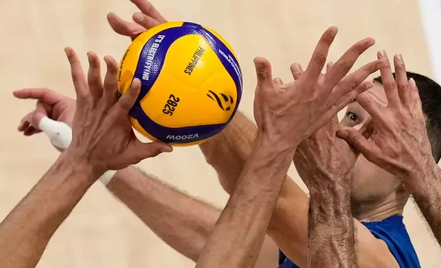 Pavle Peric of Serbia is blocked by Iran players during a round of 16 match at the 2025 FIVB Volleyball Men's World Championship at the Mall of Asia Arena in Pasay city, Philippines, Sept. 23, 2025. (AP Photo/Aaron Favila, File)