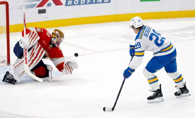 Florida Panthers goaltender Daniil Tarasov, left, makes a save against St. Louis Blues right wing Jonatan Berggren (29) during the second period of an NHL hockey game, Saturday, Dec. 20, 2025, in Sunrise, Fla. (AP Photo/Rhona Wise)