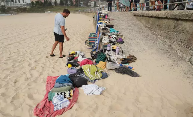 A man looks at belongings stacked up following a shooting the day prior at Sydney's Bondi Beach, Monday, Dec. 15, 2025. (AP Photo/Mark Baker)