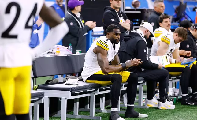 Pittsburgh Steelers' DK Metcalf sits on the bench during the second half of an NFL football game against the Detroit Lions, Sunday, Dec. 21, 2025, in Detroit. (AP Photo/Rey Del Rio)