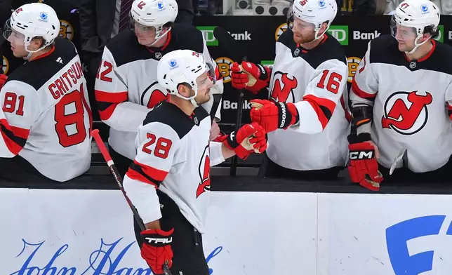 New Jersey Devils right wing Timo Meier (28) celebrates with teammates after scoring in the first period of an NHL hockey game against the Boston Bruins, Saturday, Dec. 6, 2025, in Boston. (AP Photo/Steven Senne)