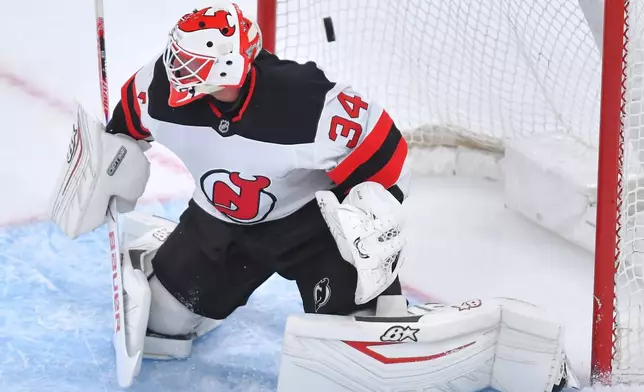 New Jersey Devils goaltender Jake Allen tries to defend as a shot by Boston Bruins center Fraser Minten flies into the net for a goal in the first period of an NHL hockey game, Saturday, Dec. 6, 2025, in Boston. (AP Photo/Steven Senne)