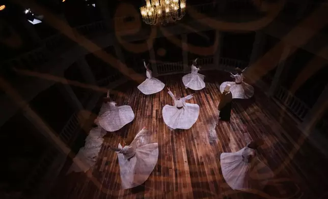 Whirling dervishes of the Mevlevi order perform during a Sheb-i Arus ceremony at Kasimpasa Mevlevihane in Istanbul, Turkey, Thursday, Dec. 11, 2024, to commemorate the death of 13th century Islamic scholar, poet and Sufi mystic Jalaladdin Rumi. (AP Photo/Francisco Seco)