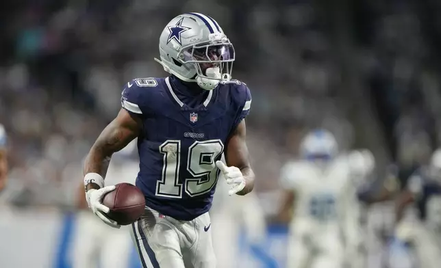 Dallas Cowboys wide receiver Ryan Flournoy runs the ball in after catching a touchdown pass against the Detroit Lions during the second half of an NFL football game Thursday, Dec. 4, 2025, in Detroit. (AP Photo/Ryan Sun)