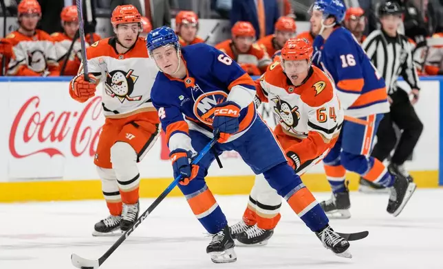 New York Islanders center Calum Ritchie (64) looks to pass during the second period of an NHL hockey game against Anaheim Ducks, Thursday, Dec. 11, 2025, in Elmont, N.Y. (AP Photo/Yuki Iwamura)